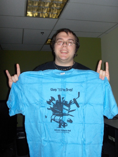 Joel holding his new pride and joy, the promo T-shirt for 'Dead Rising'